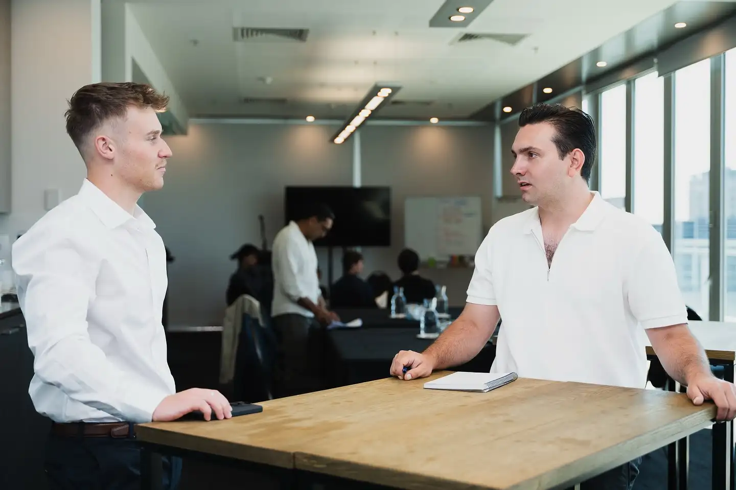 Two Ascend colleagues talking together in the office
